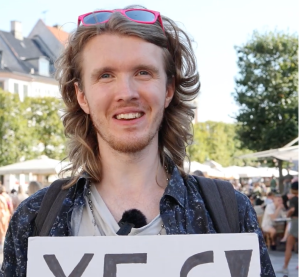 a young mand with long blond hair and red sunglasses, a participant at the yes fam adbenture