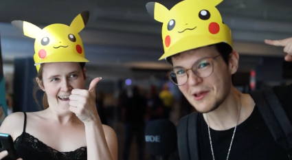 two people with picakthu paper hats at the venue malmö game week, very excited to participate in the adventure